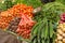 Indian vegetable market, street stall with exotic fruits and vegetables, local carrots and potatoes, paprika and tomatoes.