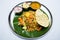 Indian vegetarian food with fried rice on banana leaf tray