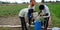 Indian village farmer filling fertilizer gallon for spraying agriculture land
