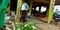 An indian village farmer having tea while standing at farmers market