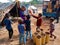 an indian village poor woman distributing chocolates to the childrens at dirty environment in India January 2020