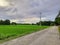 INDIAN VILLAGE ROAD ,A VAST CORN FIELD,A LARGE CLOUDY SKY