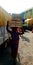 An Indian village woman carried vegetable container on head at local market