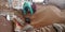 Indian village worker cleaning dust from wheat grain stock at farmers store