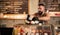 Indian waiter working in a cafe, barista putting meringue cakes on showcase of a coffee shop