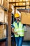 Indian warehouse worker hold cardboard box