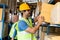 Indian warehouse worker put cardboard box in shelf