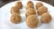 Indian white sesame seeds sweet or tilgul laddu, made up of jaggery and sesame seeds, hand made, round, indian sweet on Makar