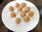 Indian white sesame seeds sweet or tilgul laddu, made up of jaggery and sesame seeds, hand made, round, indian sweet on Makar
