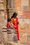 Indian woman with a child standing at Quwwat-Ul-Islam mosque, Qutub Minar, Delhi, India