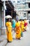 Indian woman in colorful sari carrying bale on head at crowded street