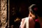 Indian woman in colorful sari prays inside Meenakshi Temple, India