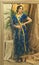 Indian woman cosplay. Young beautiful woman in blue indian sari dress closeup is looking in the mirror