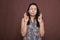 Indian woman crossing fingers, pleading for success