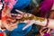 An Indian woman gets henna tattoos on the hands