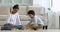 Indian woman and little son play wooden bricks at home