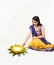 Indian woman making rangoli using flowers