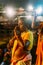 Indian woman praying on the boat in the area of Varanasi Ganga Aarti at holy Dasaswamedh Ghat, near Kashi Vishwanath Temple.