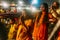 Indian woman praying on the boat in the area of Varanasi Ganga Aarti at holy Dasaswamedh Ghat, near Kashi Vishwanath Temple.