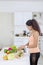 Indian woman preparing a tasty salad in kitchen