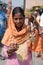 Indian woman selling beaded necklaces to tourists on streets of India