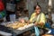 Indian woman selling seafood, fish and clams on the street in Mumbai. India
