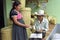 Indian woman sells wicker baskets to shopkeeper