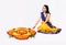 Indian woman or young girl making floral or flower rangoli for diwali or onam, isolated over white background