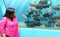 An Indian women checking out the aquatic life in Lokaranjan Underwater Aquarium, Mysore