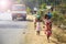 Indian women and girls carry jugs of water on their heads along the road