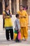 Indian women with kids standing in the courtyard of Quwwat-Ul-Islam mosque, Qutub Minar, Delhi, India