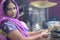 Indian women making chapati and thekua or bananas during the festival of Chhath Puja.