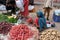 Indian women sell fruit and vegetables by the side of the road in Jaipur