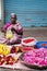 Indian women selling colorful flower garland at street market place for religion ceremony