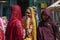 Indian women traditionally dressed shopping at vegetable market