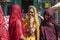 Indian women traditionally dressed shopping at vegetable market