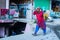 Indian Women walking on street.lifting heavy electric cable roll on her head