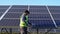 Indian worker cleaning solar panels after installation outdoors