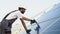 Indian worker installing solar panels on the house roof