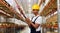 Indian worker using smartphone at warehouse