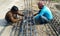 Indian workers.Two workers checking the durability of the steel structure.