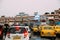 Indian yellow taxis and other cars waiting in the rain with umbrella near the area of Howrah Junction railway station
