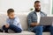 Indifferent Black Father Neglecting Son Using Laptop Sitting At Home