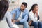 Indifferent black spouses sitting on couch at marital therapist`s office.