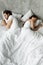 Indifferent couple sleep separately avoiding intimacy in bed