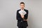 Indifferent young business man in classic black suit holding lots bunch of dollars banknotes, cash money isolated on