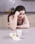 Indifferent young woman looking at a yoghurt spilt