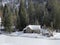 Indigenous alpine huts and wooden cattle stables on Swiss pastures covered with fresh white snow cover, Unterwasser