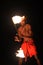 Indigenous Fijian man holds a torch during a fire dance