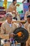 Indigenous senior man holding and hitting gong.